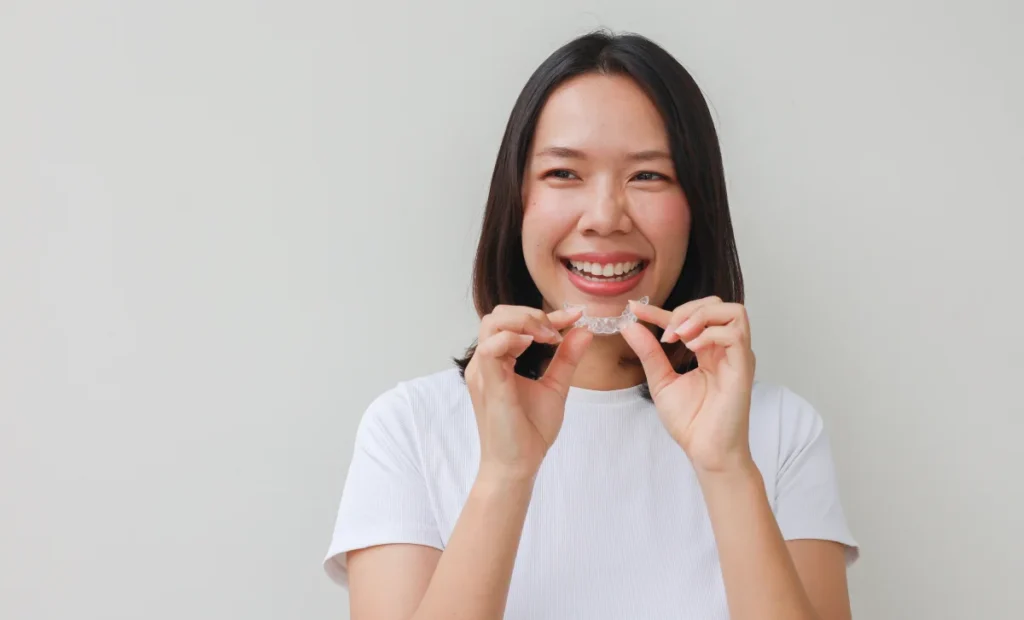 An Asian Woman Wearing Invisalign Aligners