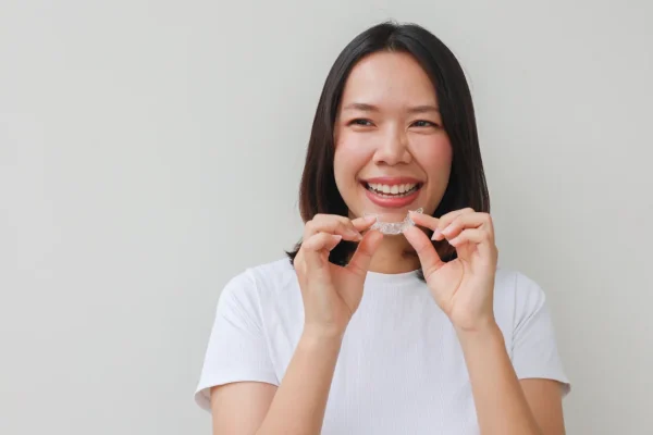 An Asian Woman Wearing Invisalign Aligners